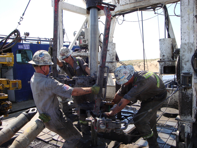 Picture of people manually drilling.